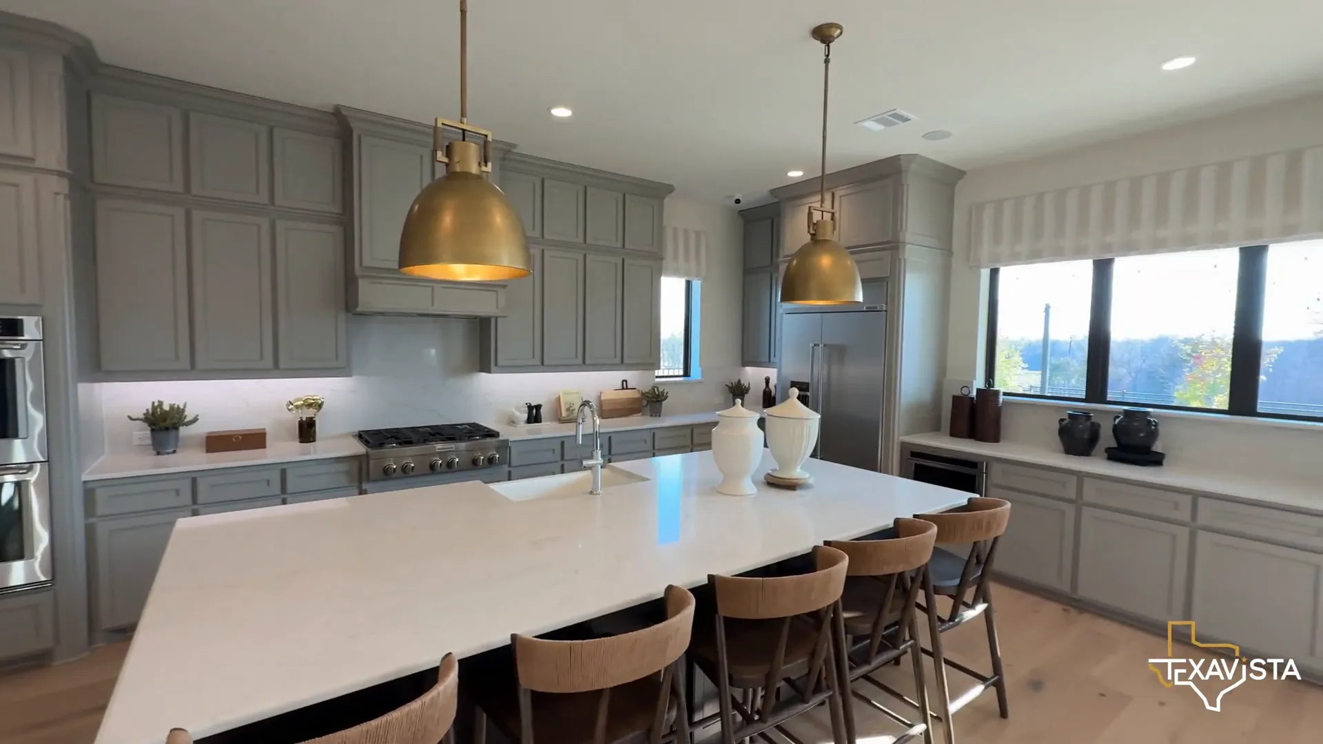 Chef's kitchen with six-burner stove and large island in Toll Brothers home