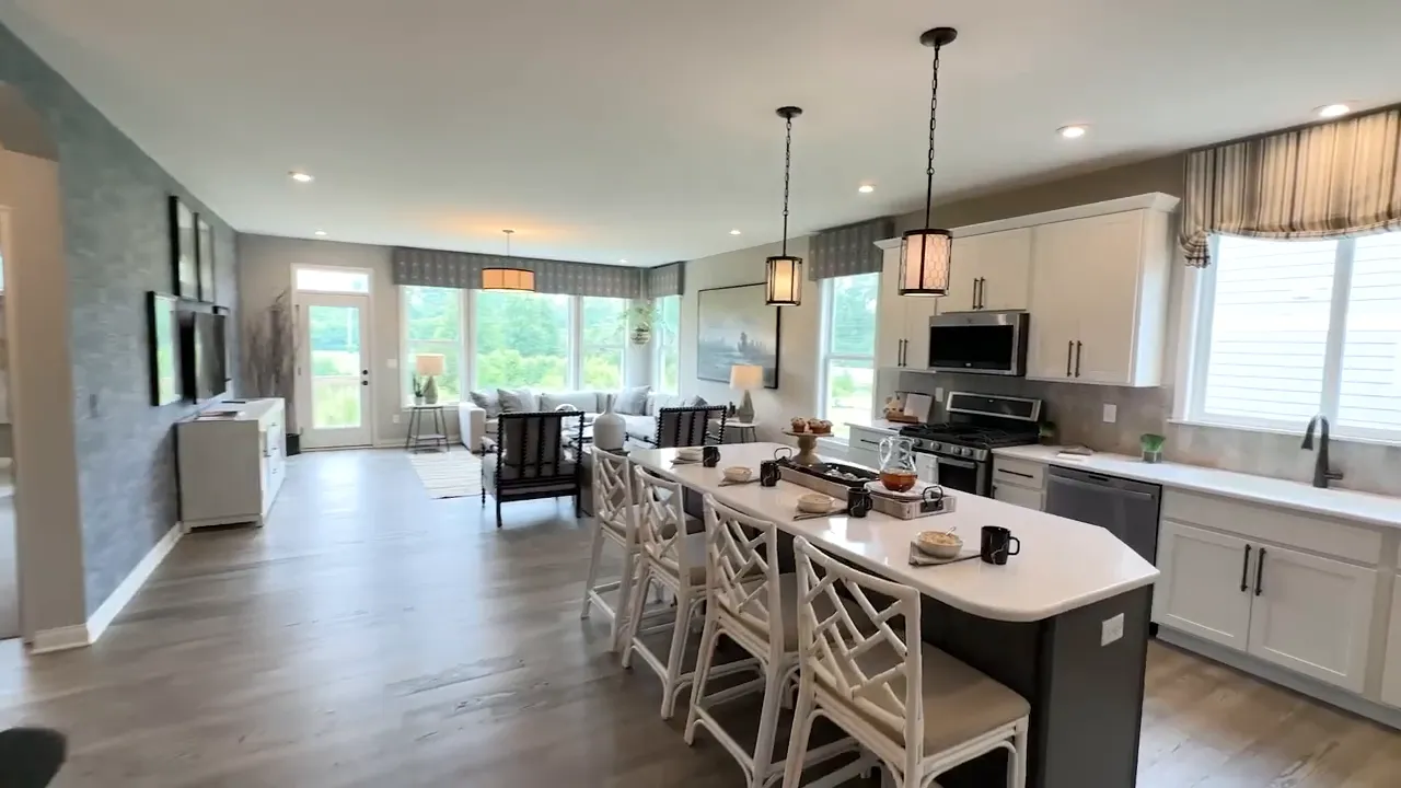 Bright modern kitchen and dining area with a large island and white stools