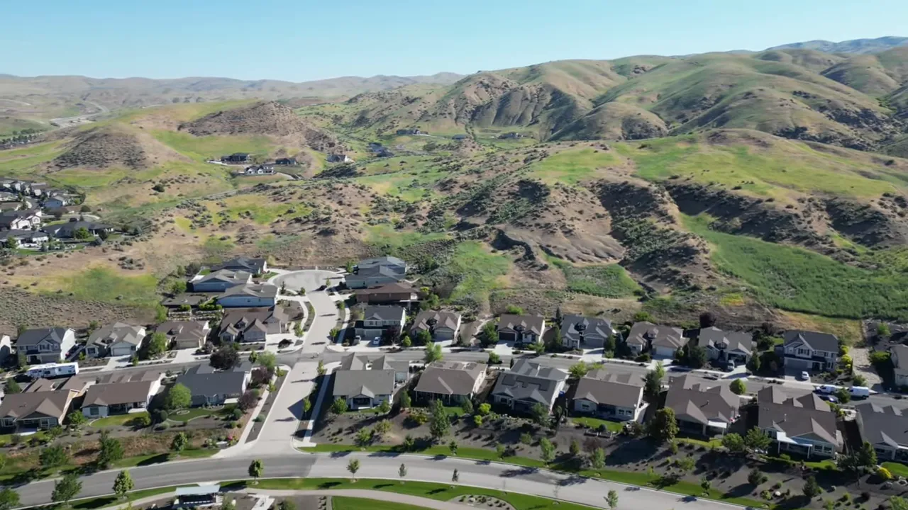 Clear aerial view of Avimor homes fronting open foothills and trail-connected green space