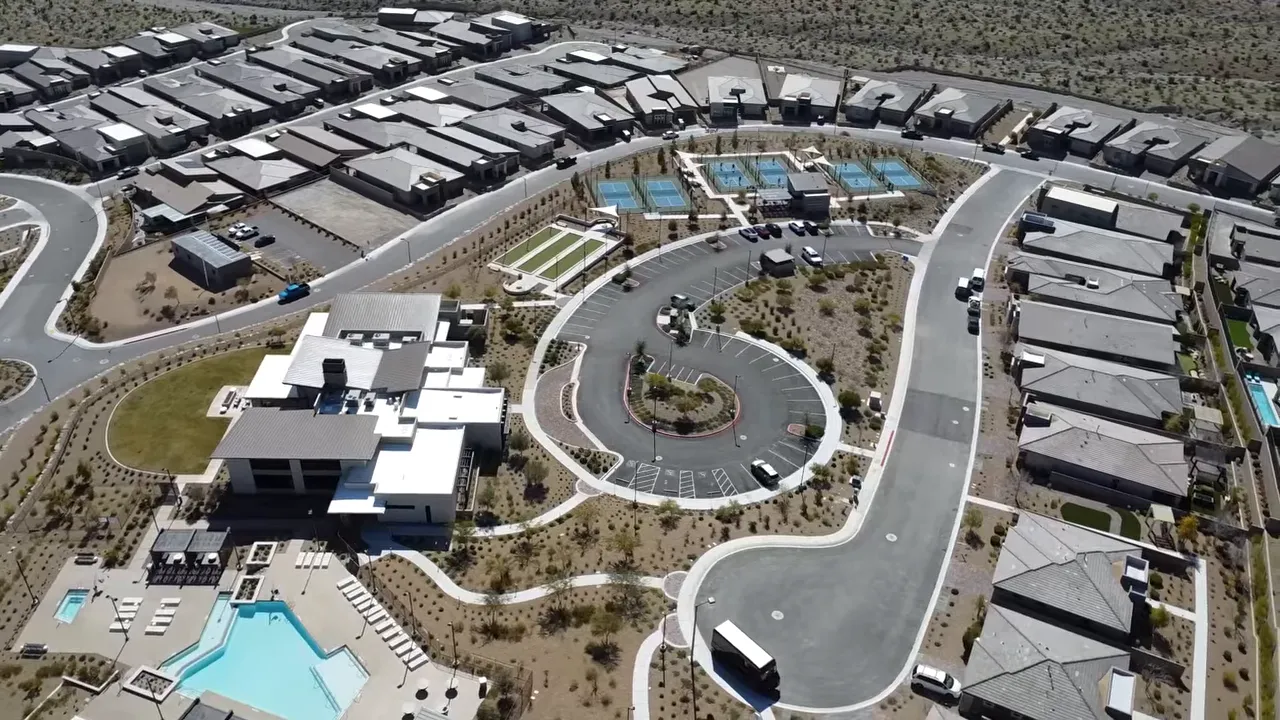 Aerial view of community clubhouse pool courts and surrounding homes