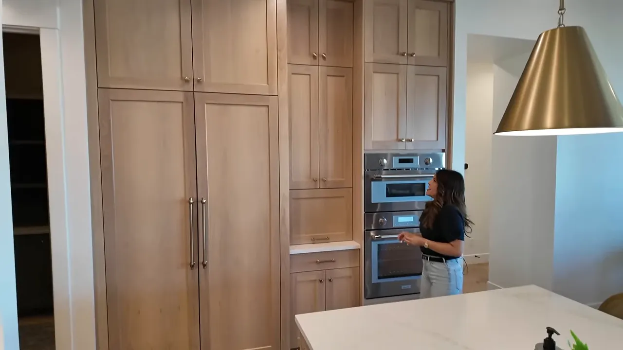 Kitchen cooking wall with tall cabinets custom wood hood and gas range