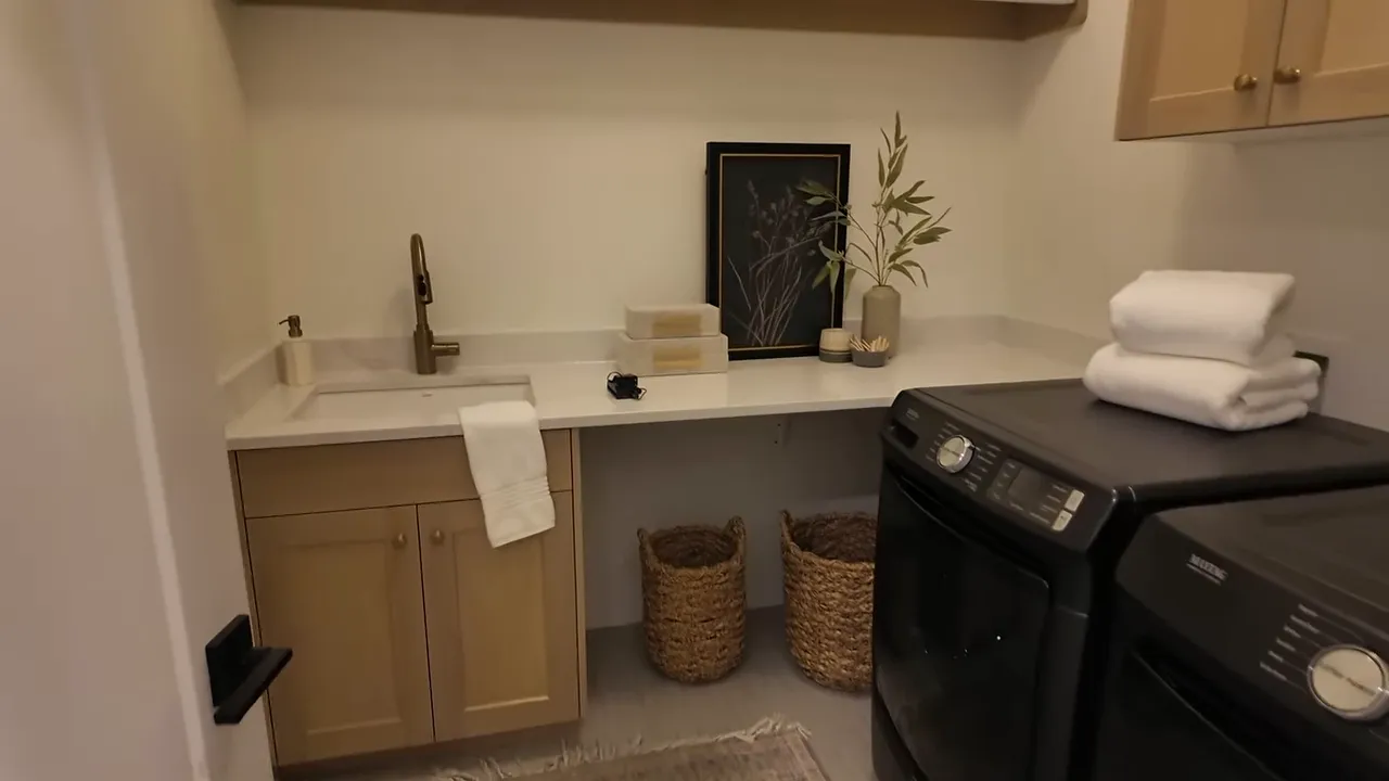Laundry room with sink counter washer dryer and long shelf above