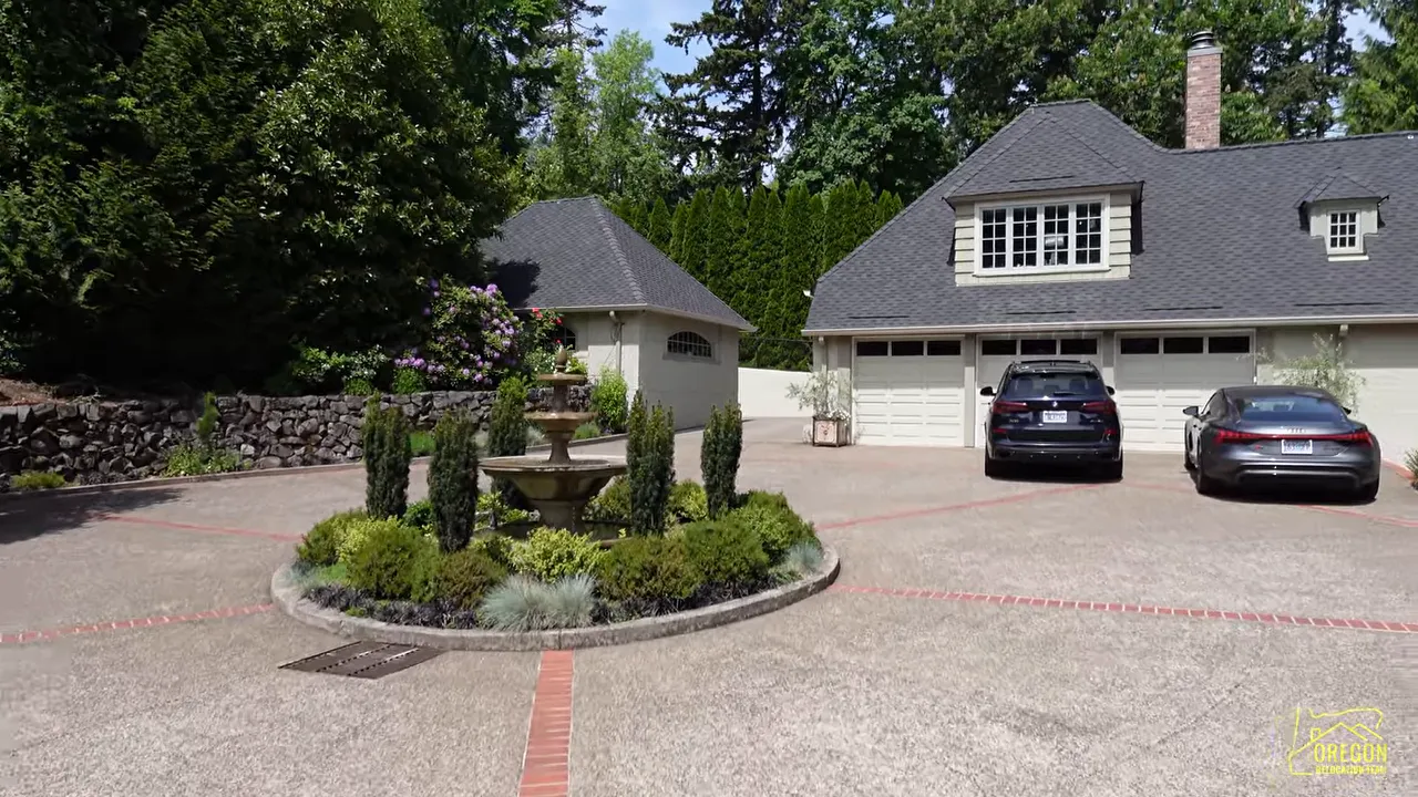 Circular motor court with central fountain detached garage and large estate buildings