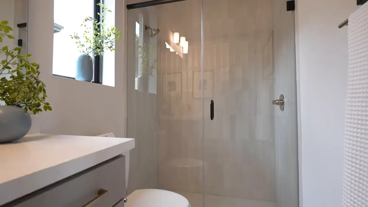 Glass shower and bright bathroom interior in a Palmera Ridge primary suite