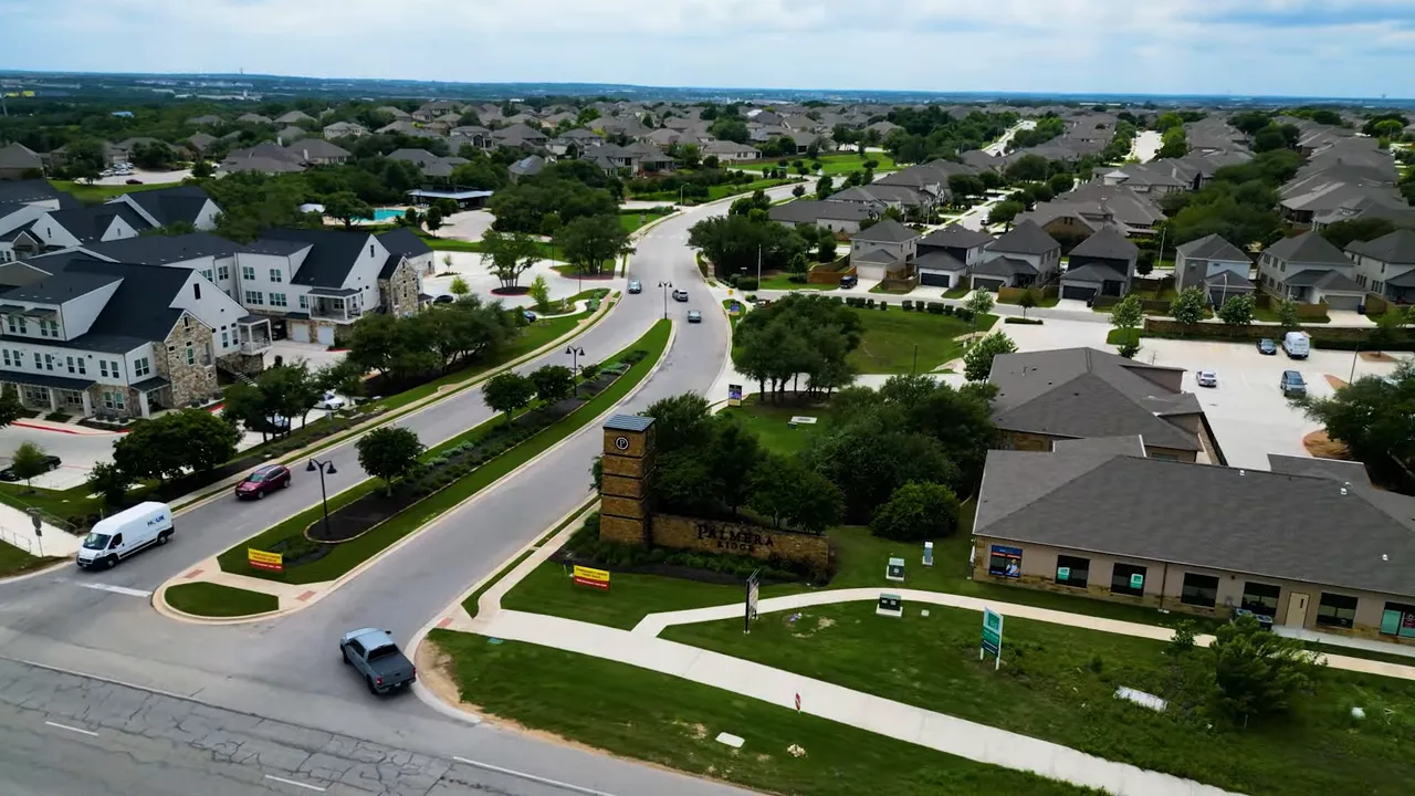 Aerial view of Palmera Ridge neighborhood entrance and community streets in Leander TX
