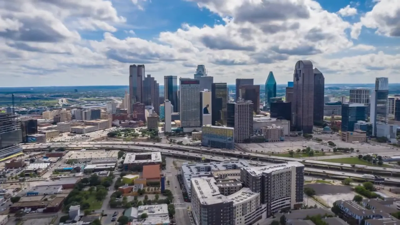 Dallas skyline aerial with text showing population of 8000000 plus