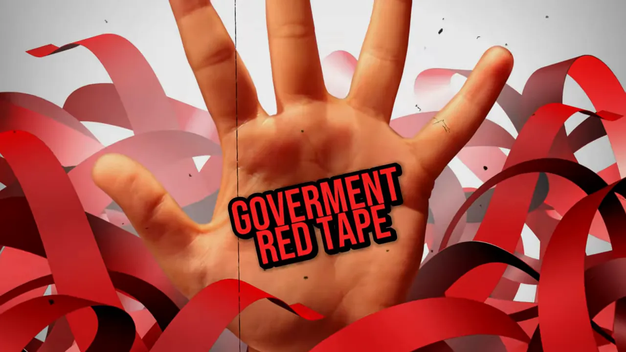 Hand with red government red tape label over housing approvals backdrop