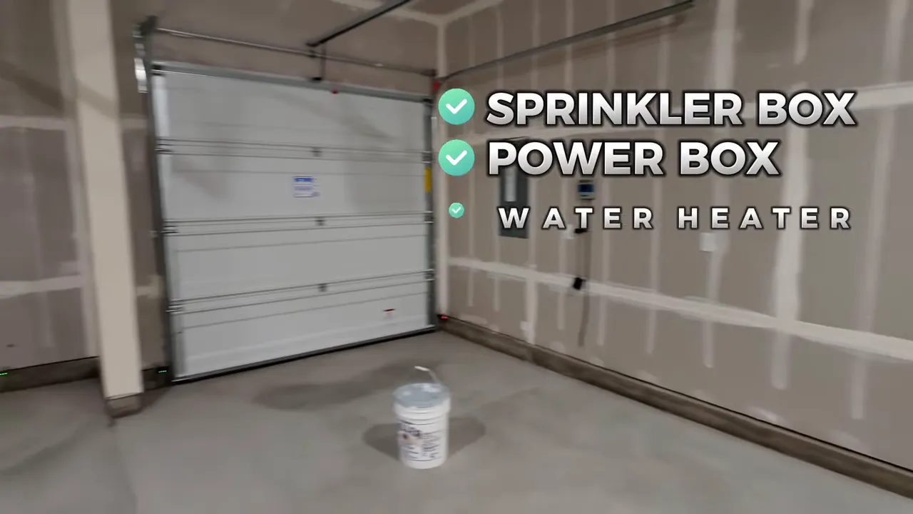 Garage interior showing garage door, labeled sprinkler box, power box and water heater near the wall