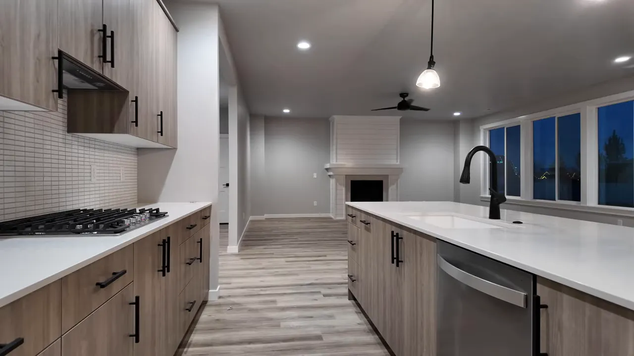 Open kitchen with large quartz island, undermount sink and black faucet, gas cooktop and wood-tone cabinetry