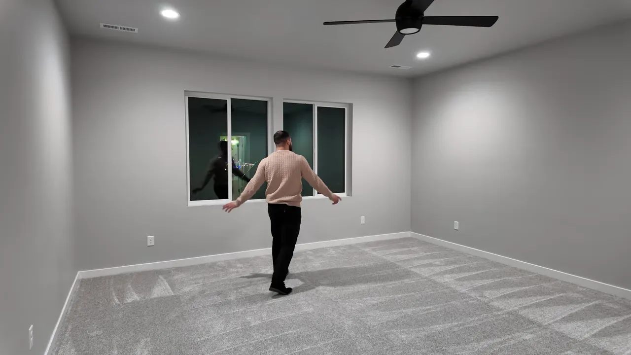 wide-angle primary bedroom view with carpet, window and ceiling fan
