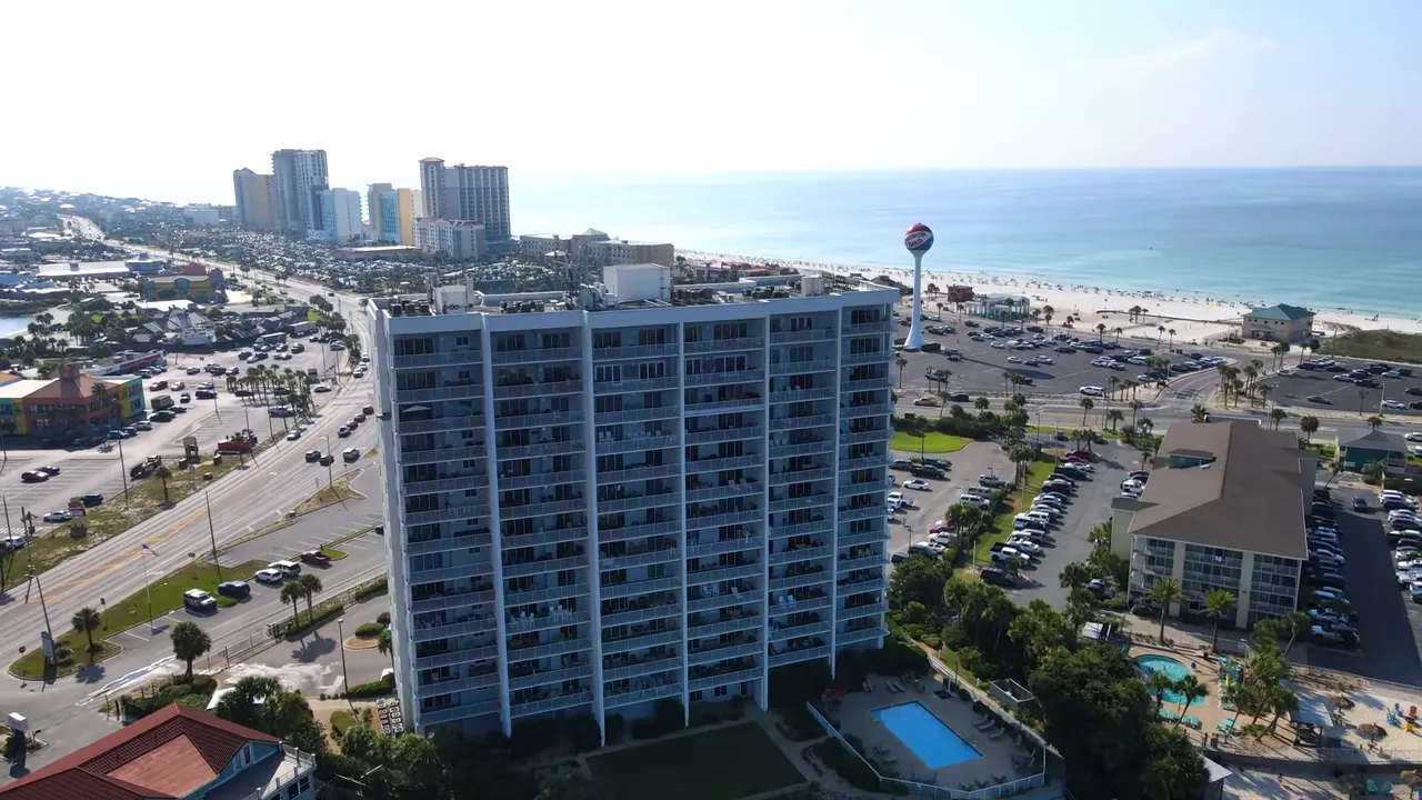 Aerial view of Pensacola Beach showing hotels, roads, and the shoreline