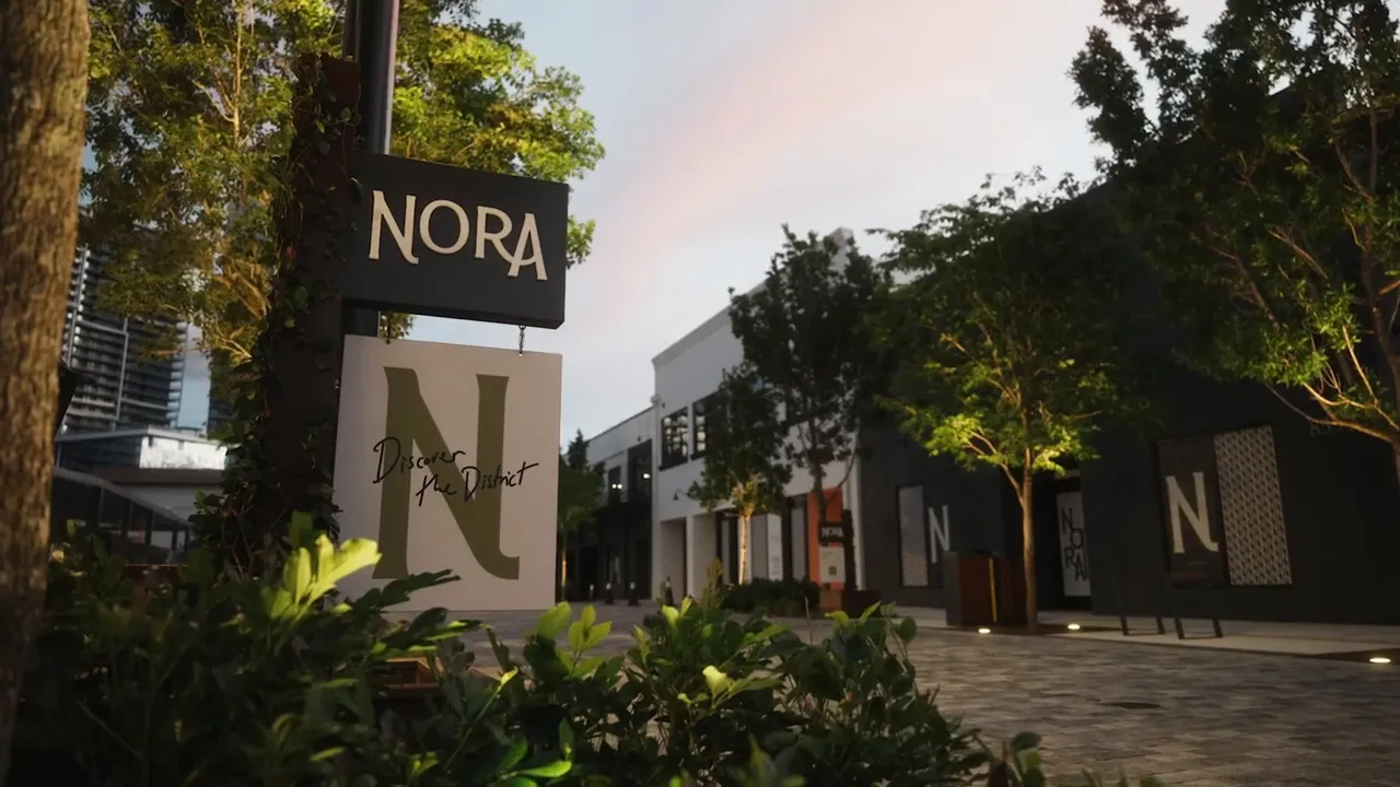 Nora district sign with large letter N markers along a landscaped pedestrian street