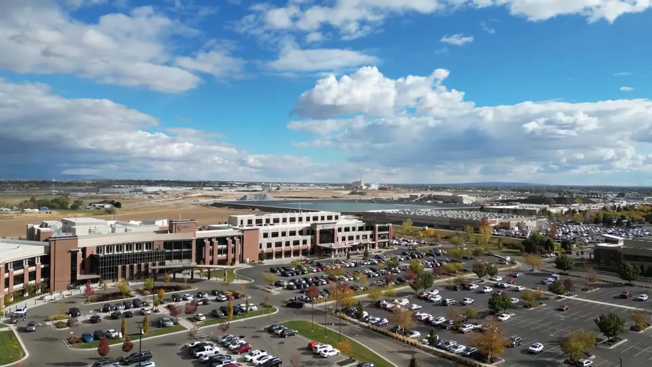 Aerial view of major commercial buildings parking areas and open land