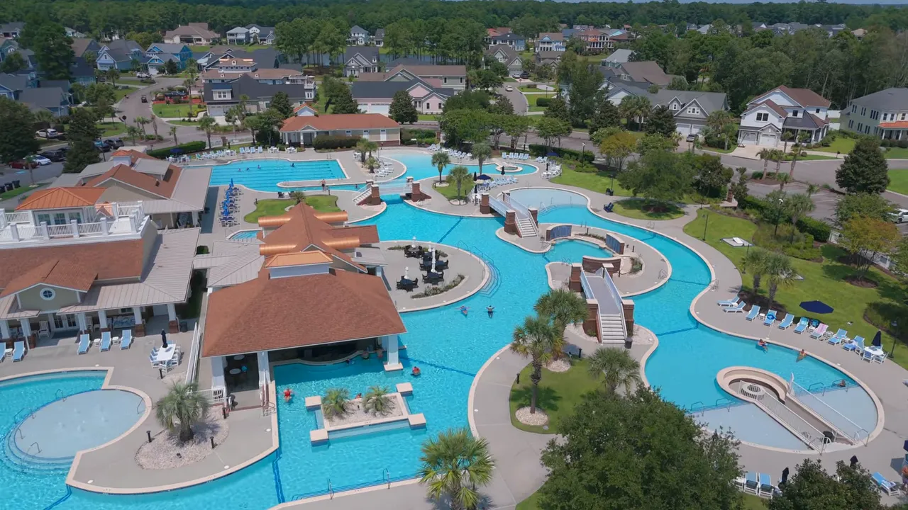 Aerial view of expansive resort style pool complex with winding pools and water features