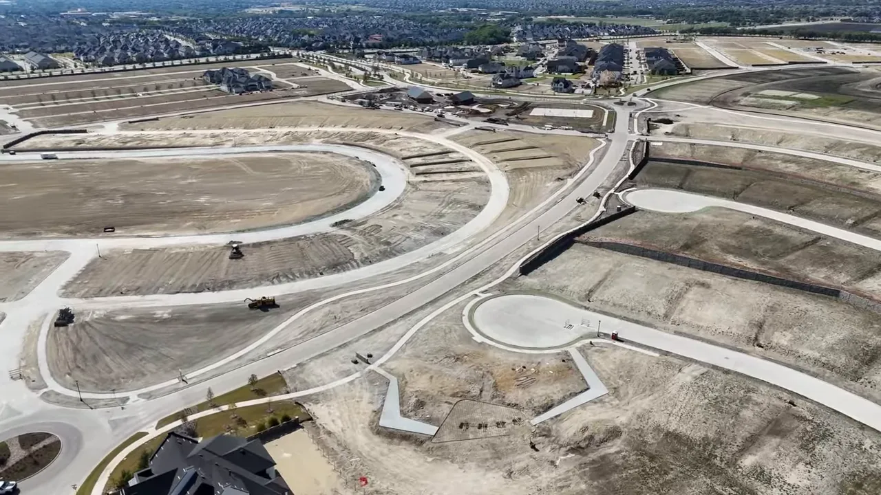 Aerial shot of new development showing cul-de-sacs, graded lot pads and road network