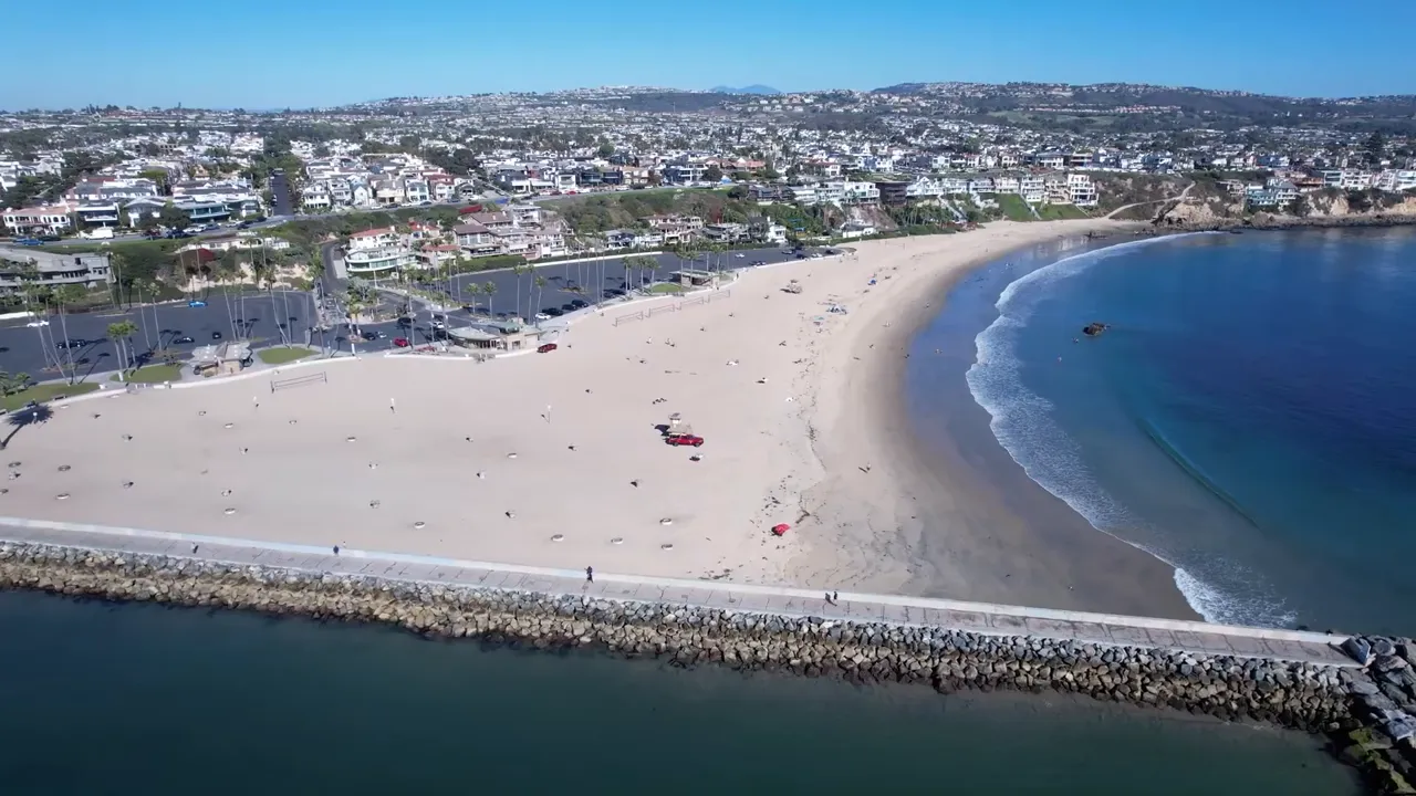 Aerial view of sandy beach and blue ocean in Corona del Mar