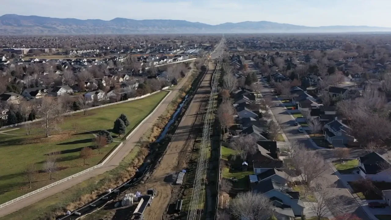 Aerial view of housing neighborhoods along a busy roadway in Idaho