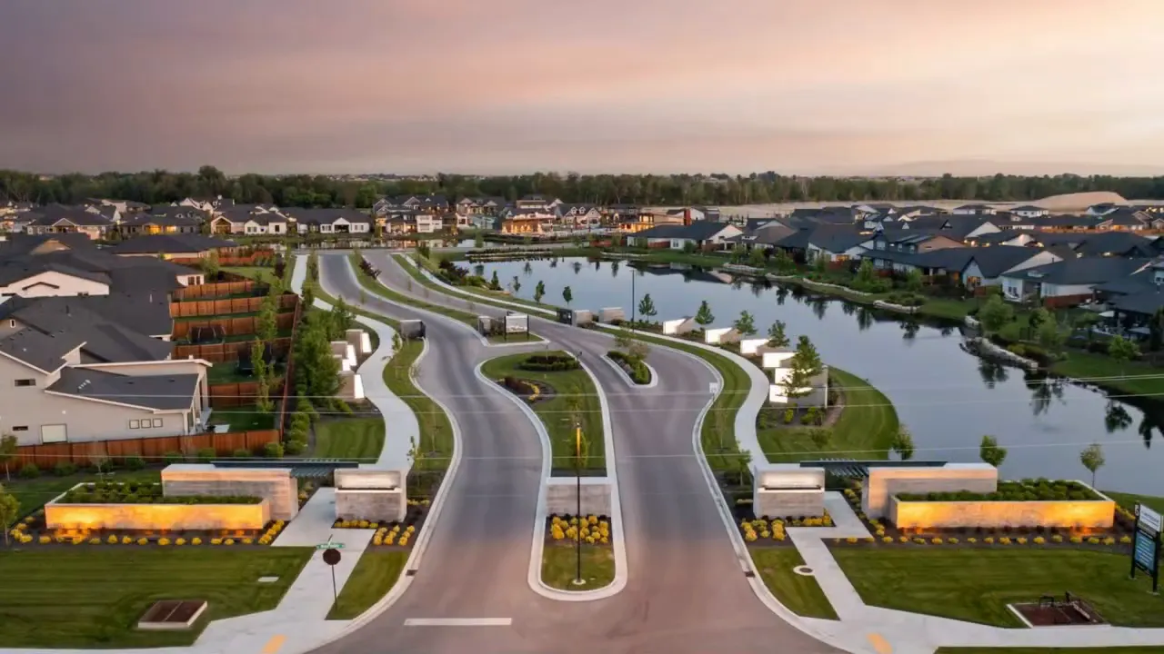 Aerial view of a planned Idaho neighborhood with curved streets and homes near a canal