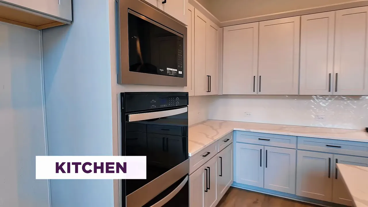Modern kitchen with stainless appliances and white cabinetry in a Frisco TX new construction home