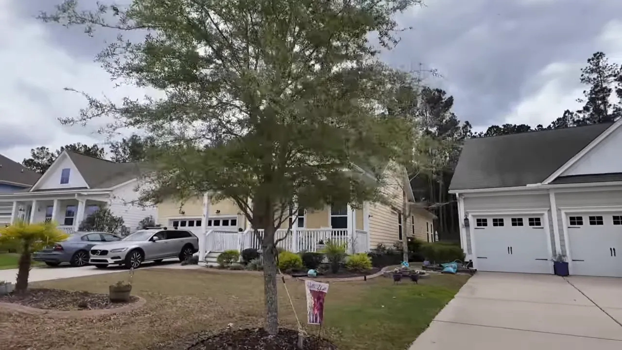 Exterior view of a newer suburban home with garage, driveway, and landscaped yard