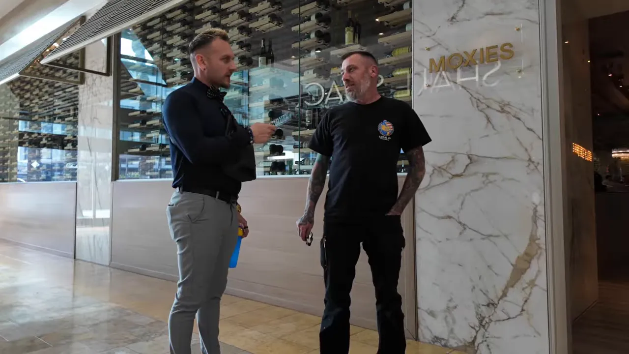 Real estate interview conversation between two men standing in front of glass storefront