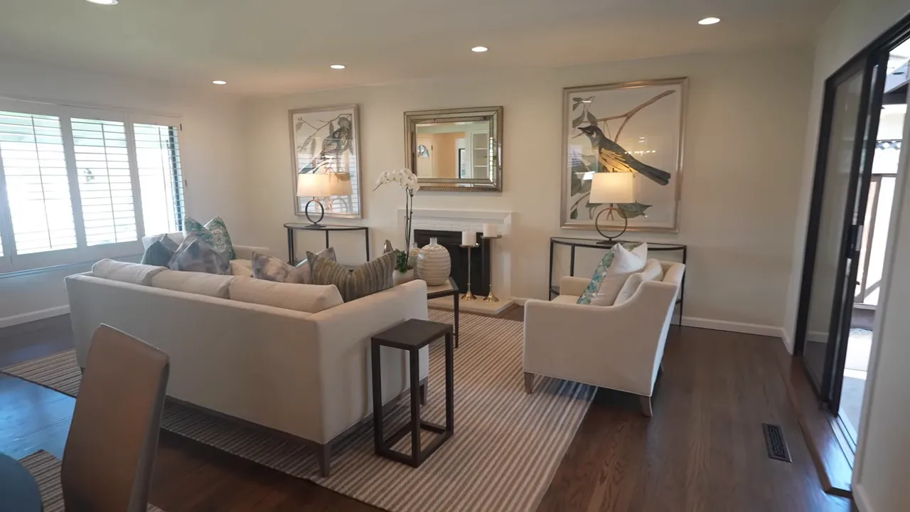 Living room and dining area with hardwood floors and staged furniture
