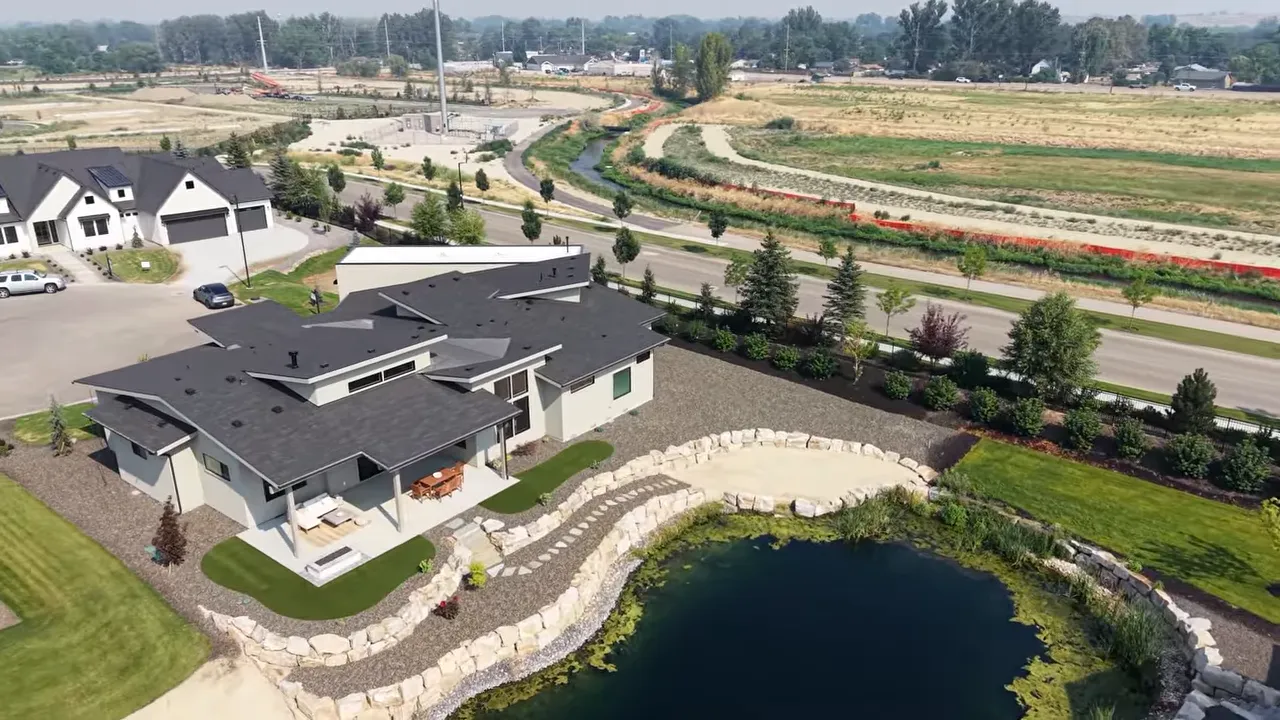 Aerial view of homes beside a pond and river corridor