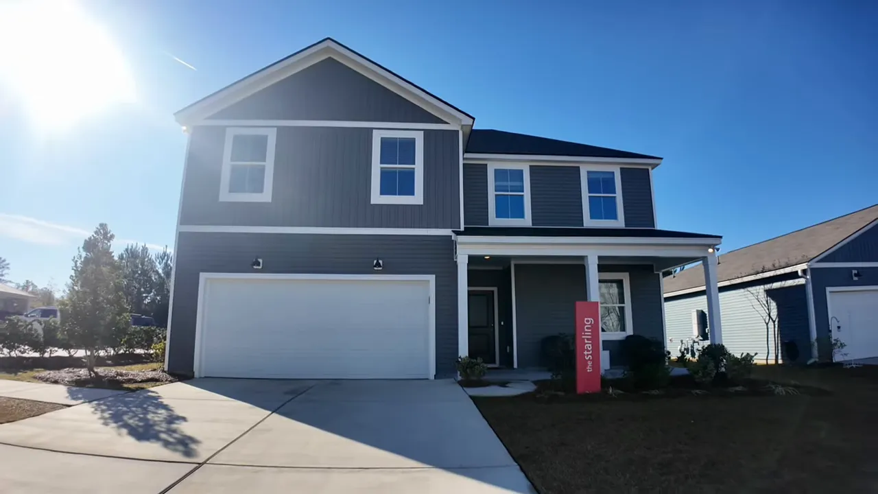 front exterior of the Starling two-story model home with driveway, garage and a red model sign