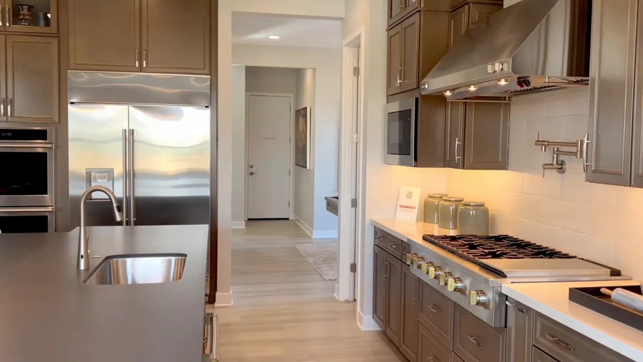 Modern kitchen with island pendant lights and built in appliances