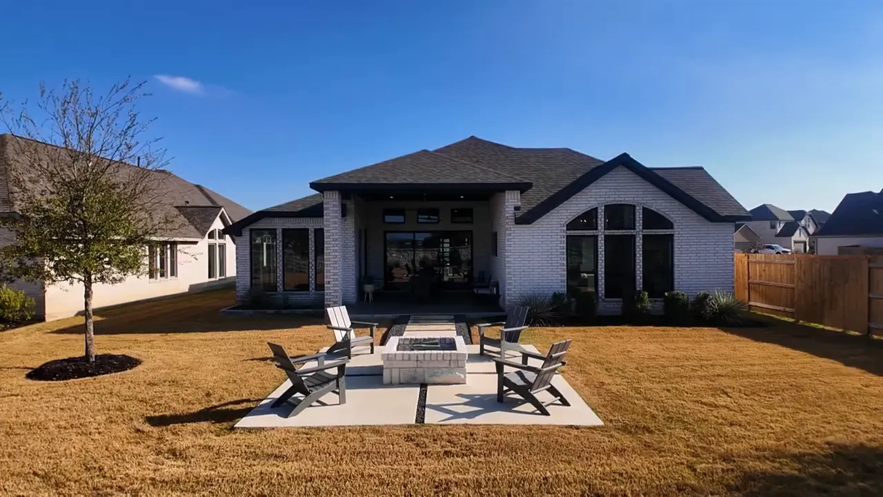 Backyard view showing covered patio lawn and wide spacing between homes