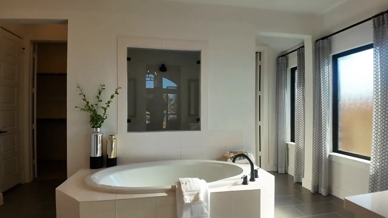 Primary bathroom with oversized tub window and bright neutral finishes