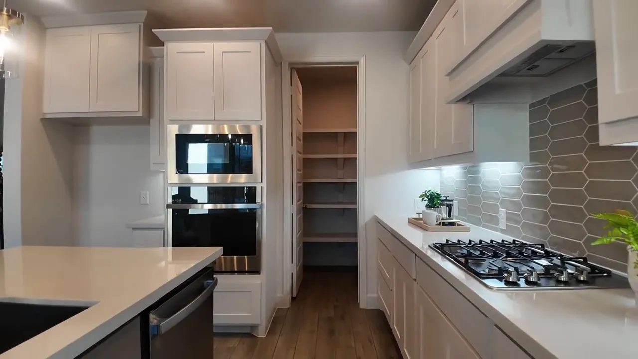 Kitchen and dining area in two story home with large island and bright windows