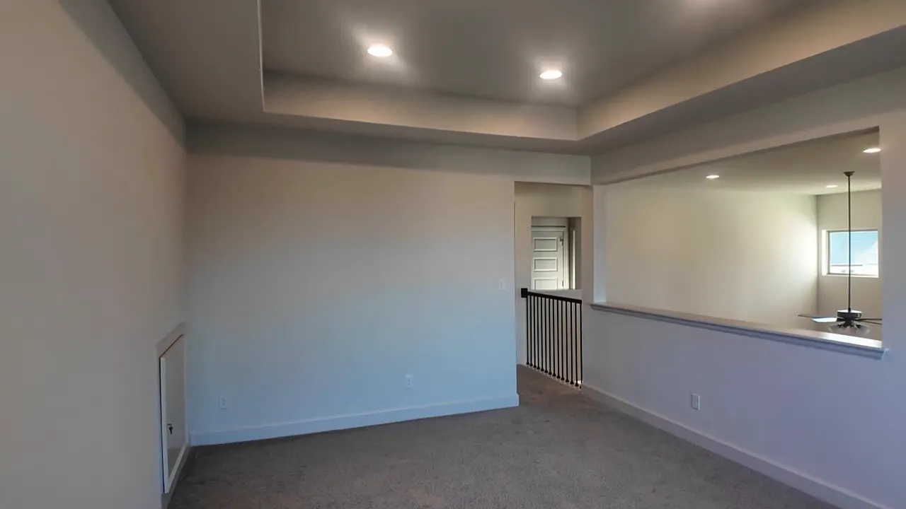 Upstairs game room with recessed lighting open railing and windows