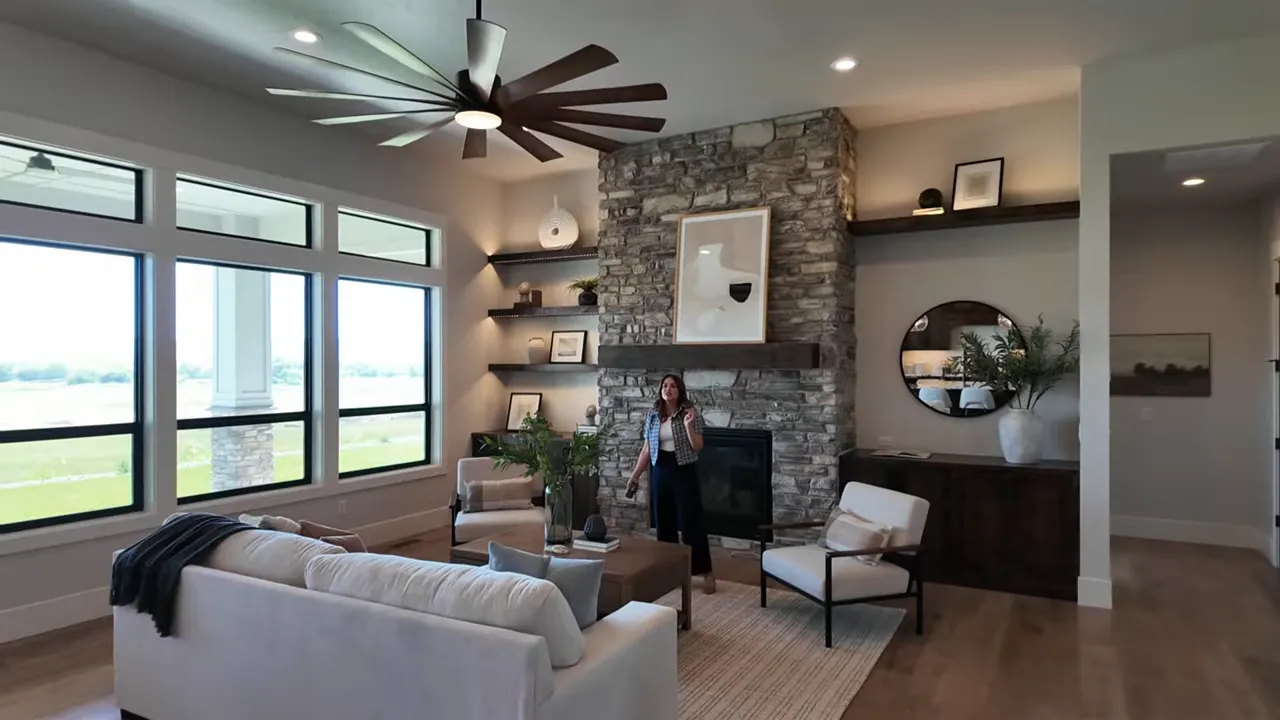 Large living room with airplane-style ceiling fan and high ceilings