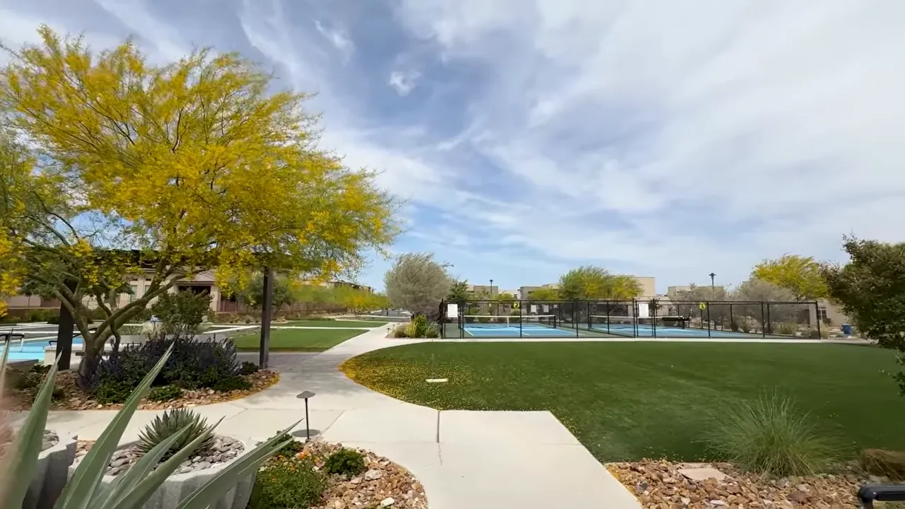 Outdoor walkway leading to resort pool area with landscaped garden at Trilogy in Summerlin