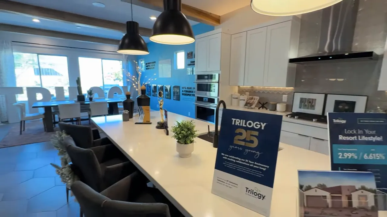 Trilogy Sunstone model home interior showing informational signage for three home collections