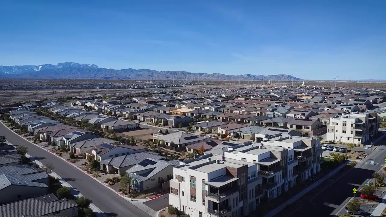 Aerial view of Trilogy Sunstone residential streets and rooftops with clear desert sky