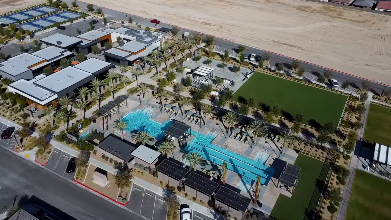 Aerial view of Trilogy Sunstone Cabochon Club featuring resort pools, lounge areas, and landscaped grounds