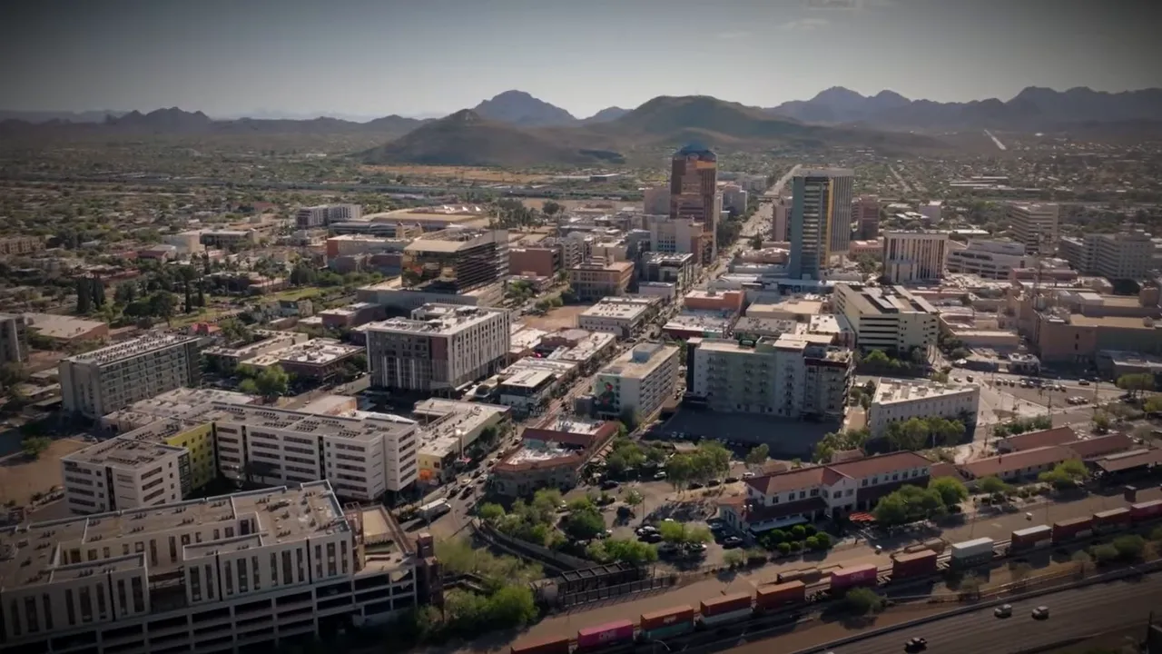 Aerial view of downtown Tucson buildings and streets with mountains in the distance