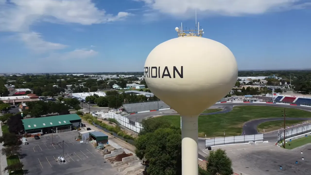 Wide aerial view of Meridian water tower with surrounding retail and stadium area