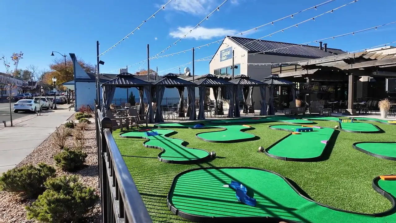 Outdoor mini golf course in Louisville Colorado with patio seating and string lights