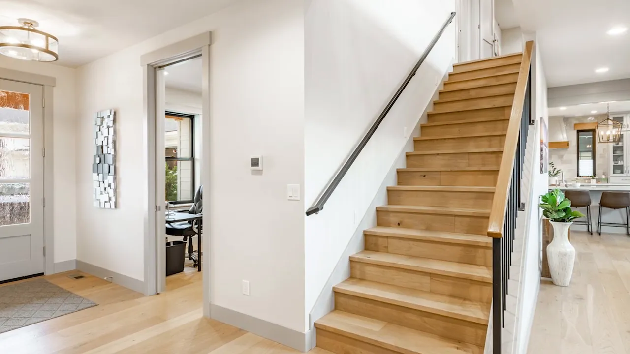 Home interior stairway with a handrail installed along the wall