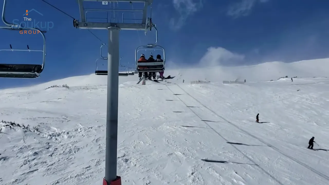 Ski lift rising above a snowy mountain slope