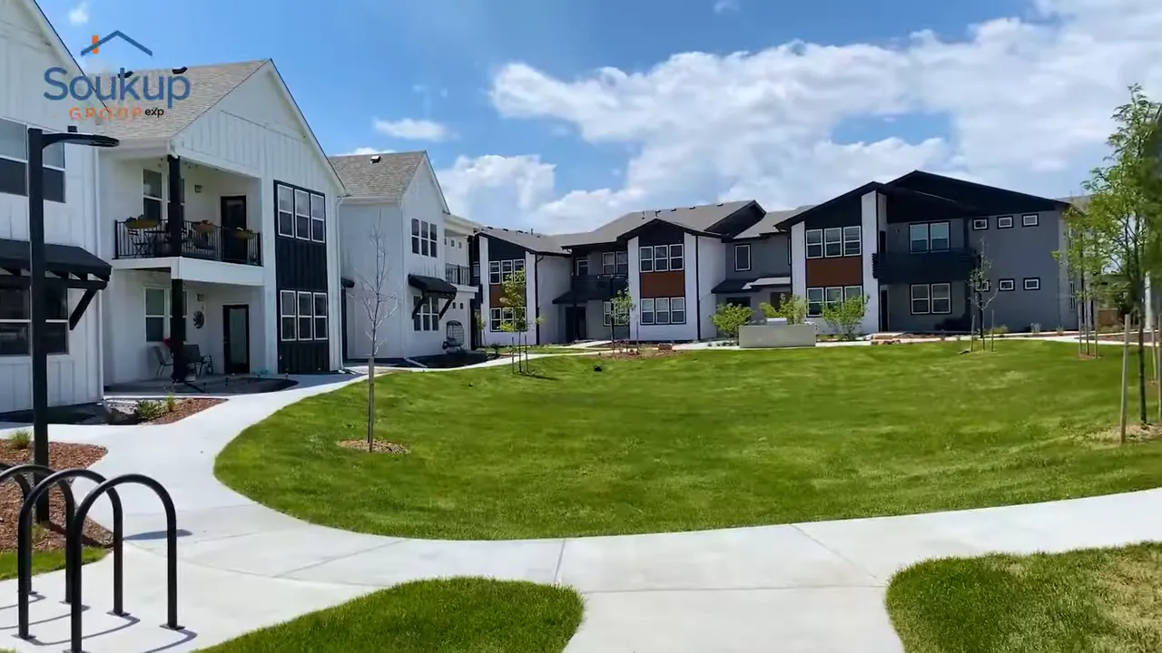 Modern apartment buildings around a green lawn