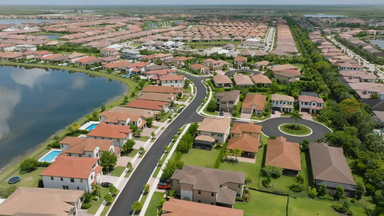 Aerial view of Parkland Bay community with lake and rows of single-family homes