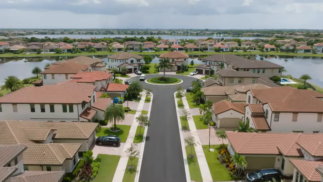 Aerial view of a Parkland Bay neighborhood street lined with homes and the central lake in the background