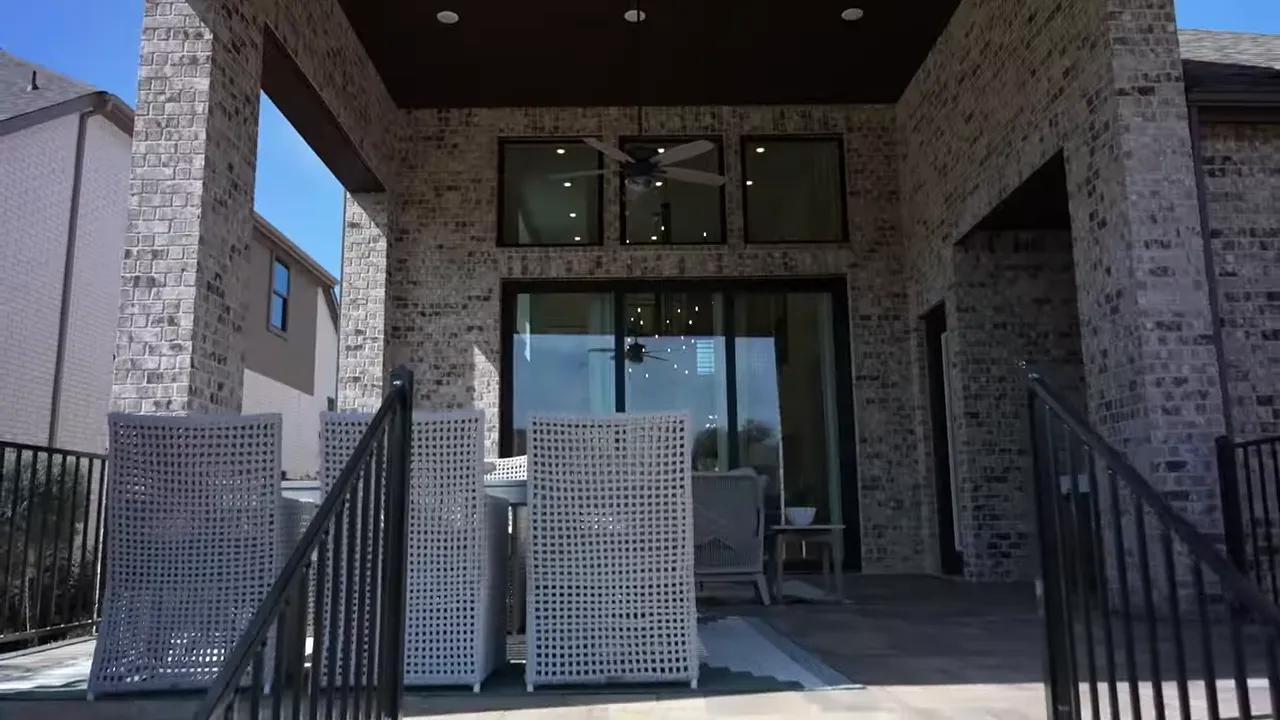 Covered back patio view in a Parkside On The River home showing seating and outdoor living layout