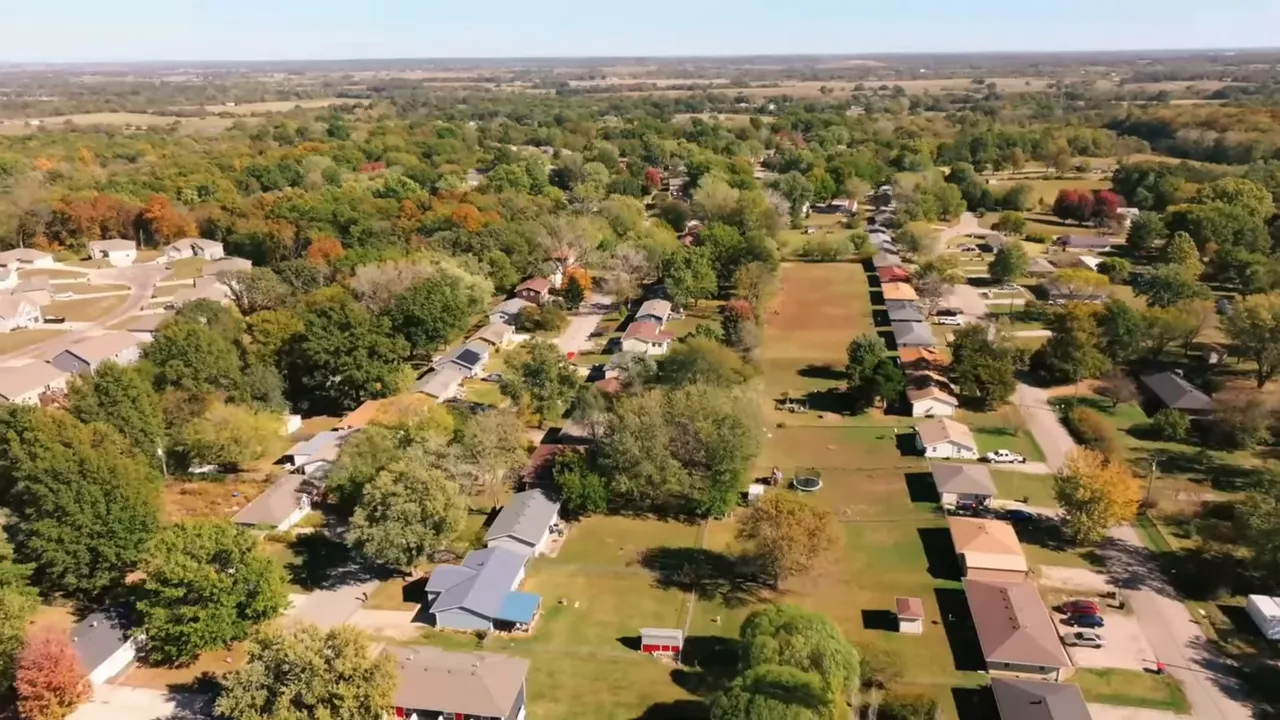 Aerial aerial view of the Valley View neighborhood in Warrensburg, Missouri showing homes, yards, and surrounding green landscape