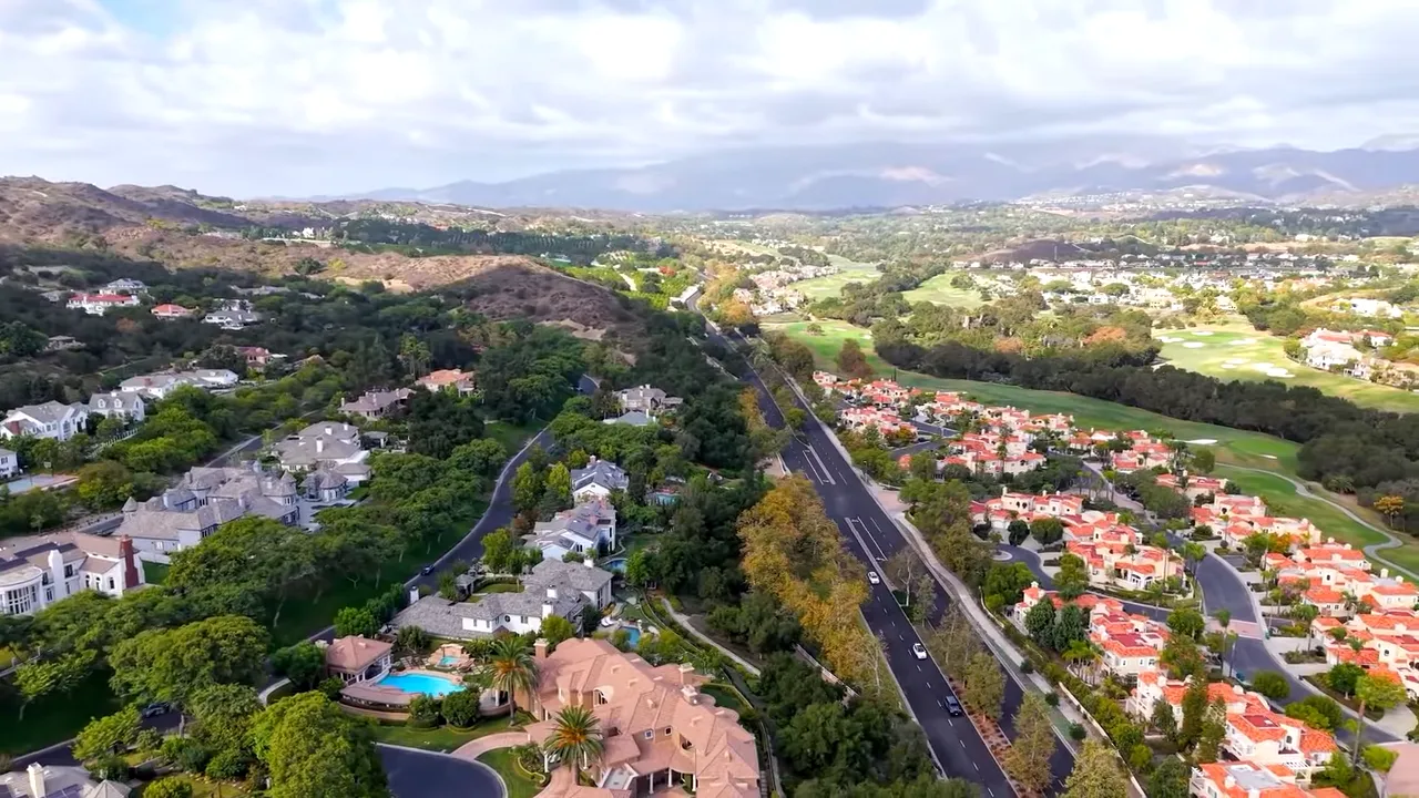 Aerial neighborhood view of Coto de Caza with golf-course-like greens and hills