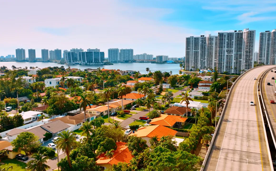 Aerial view of Palm Beach County neighborhoods and highways with the waterfront in the distance